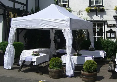 Garden party marquee with open sides and ambient lighting